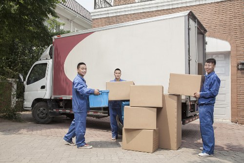 Moving team handling boxes and furniture in a Haringey flat