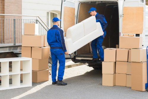 Removal team handling furniture in a Haringey home move