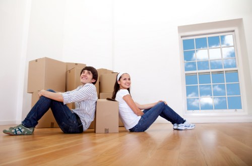 Van removal staff handling boxes and furniture with attention to safety